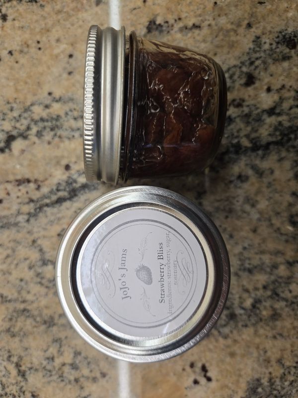 A pot of JoJo's Strawberry Bliss jam with its label